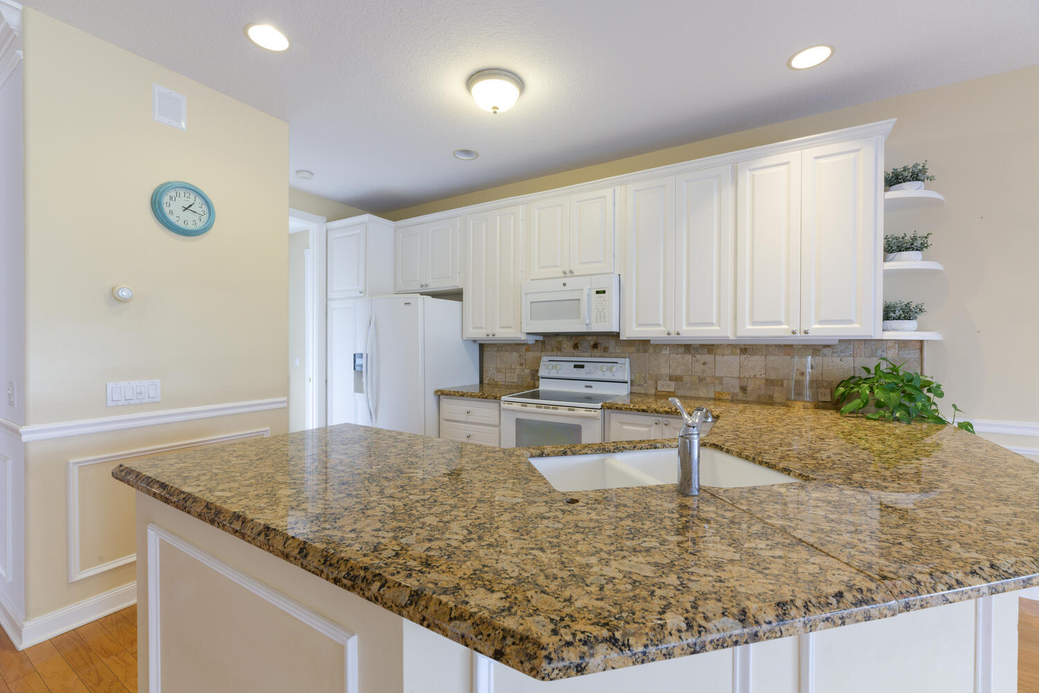 244 Barbados Drive Jupiter, FL 33458 - Photo 20 of 51 a kitchen with a sink and a refrigerator