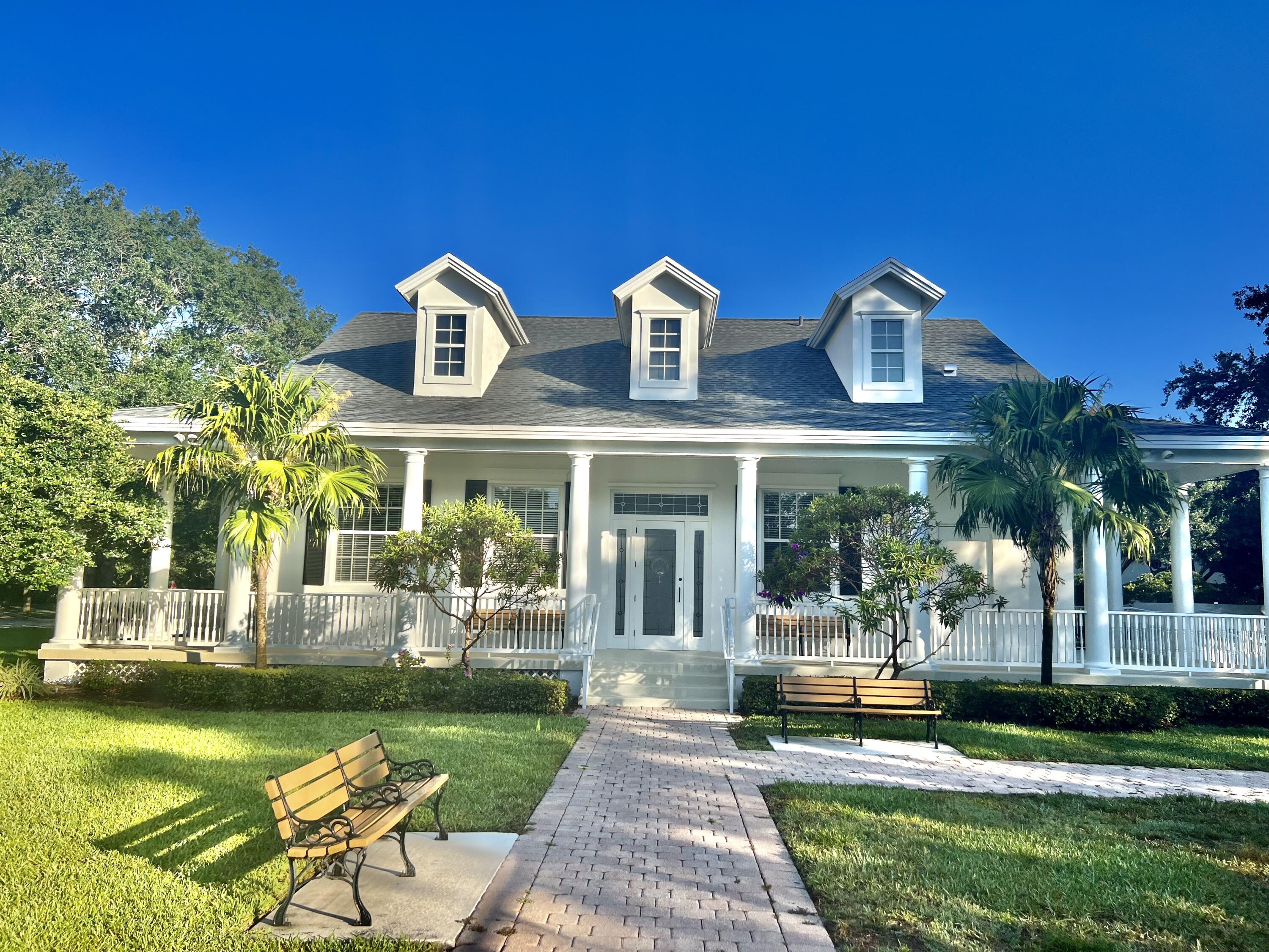 244 Barbados Drive Jupiter, FL 33458 - Photo 38 of 51 a front view of a house with garden and patio