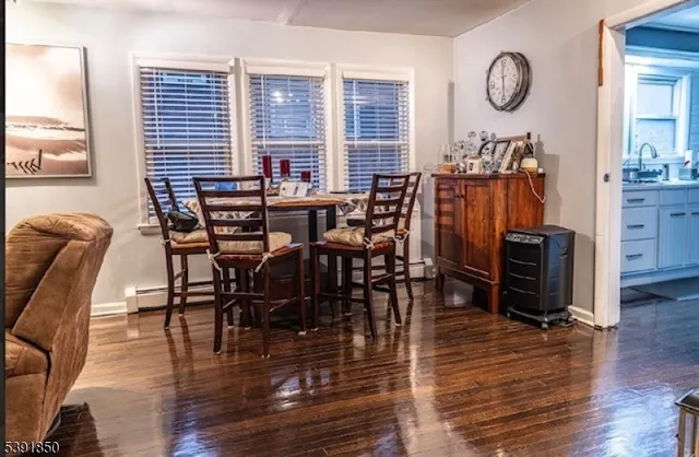 an entryway with wooden floor and a flat screen tv