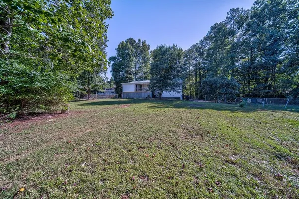 a view of a yard with a tree