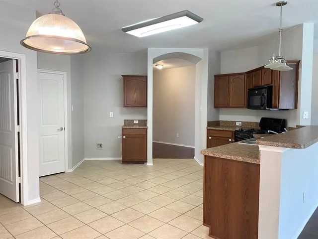 a kitchen with stainless steel appliances granite countertop a sink a stove and a refrigerator