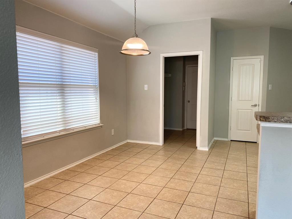 9717 Mystic Dunes Drive McKinney, TX 75072 - Photo 7 of 16 a view of an empty room with window and cabinet