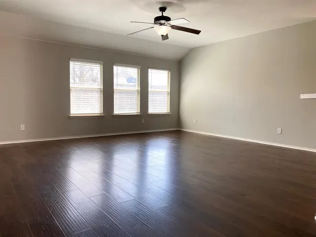 a view of wooden floor and windows in a room