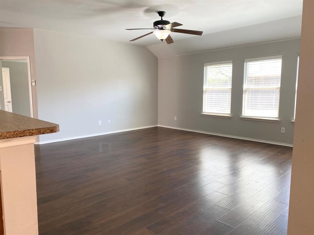 9717 Mystic Dunes Drive McKinney, TX 75072 - Photo 9 of 16 a view of a livingroom with wooden floor and a ceiling fan