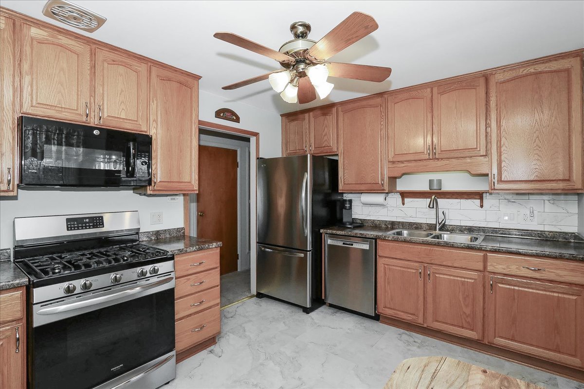 1335 Gentry Road Hoffman Estates, IL 60169 - Photo 12 of 33 a kitchen with cabinets stainless steel appliances and a counter space