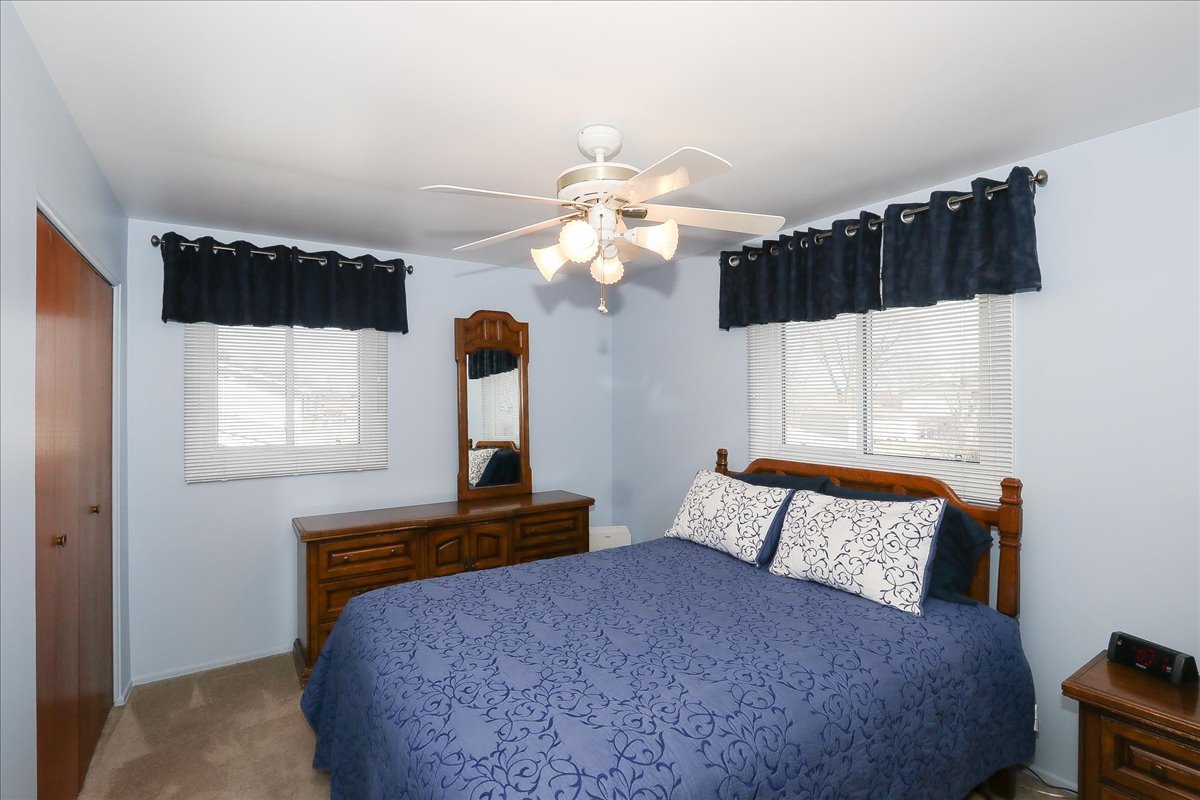 1335 Gentry Road Hoffman Estates, IL 60169 - Photo 15 of 33 a bedroom with a bed mirror and window