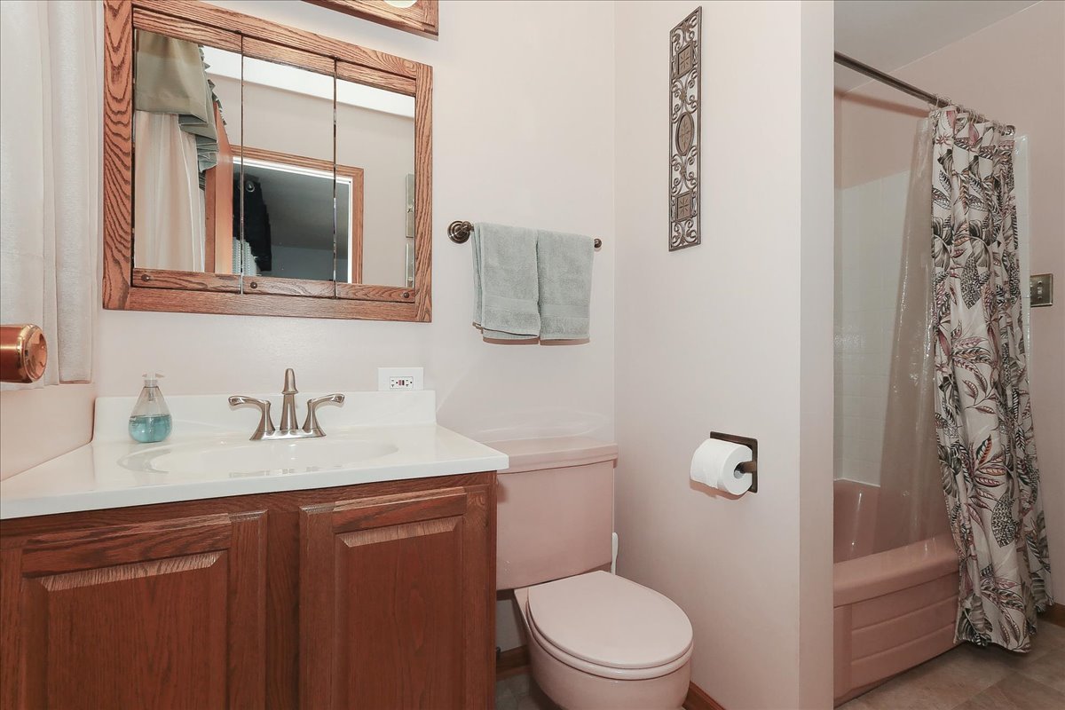 1335 Gentry Road Hoffman Estates, IL 60169 - Photo 17 of 33 a bathroom with a granite countertop toilet sink and mirror
