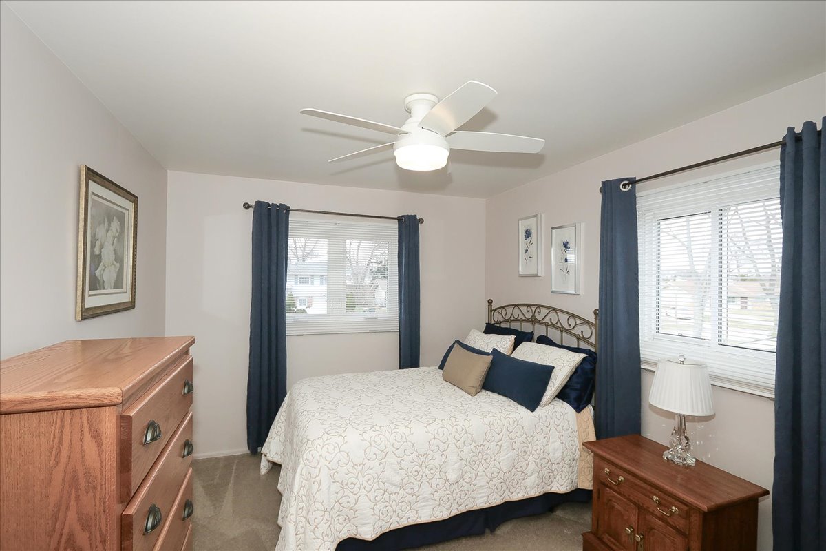 1335 Gentry Road Hoffman Estates, IL 60169 - Photo 19 of 33 a bedroom with a bed and wooden floor