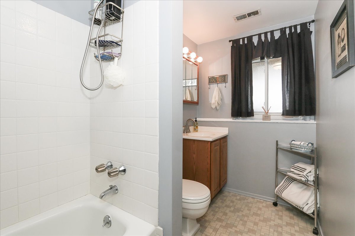 1335 Gentry Road Hoffman Estates, IL 60169 - Photo 26 of 33 a bathroom with a granite countertop sink toilet and shower