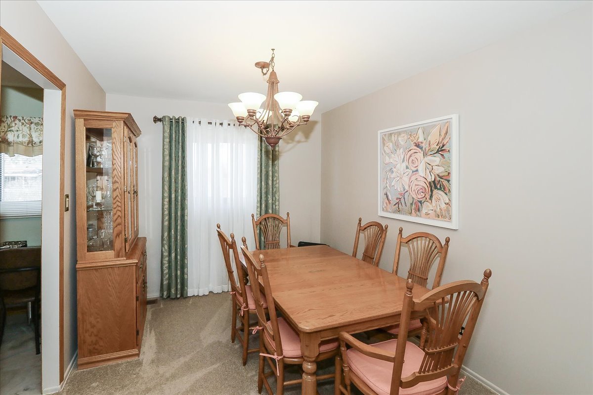 1335 Gentry Road Hoffman Estates, IL 60169 - Photo 10 of 33 a view of a dining room with furniture and chandelier