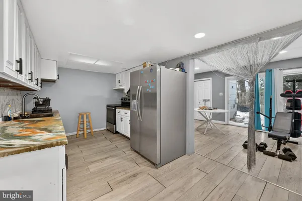 a kitchen with stainless steel appliances a refrigerator and a stove top oven