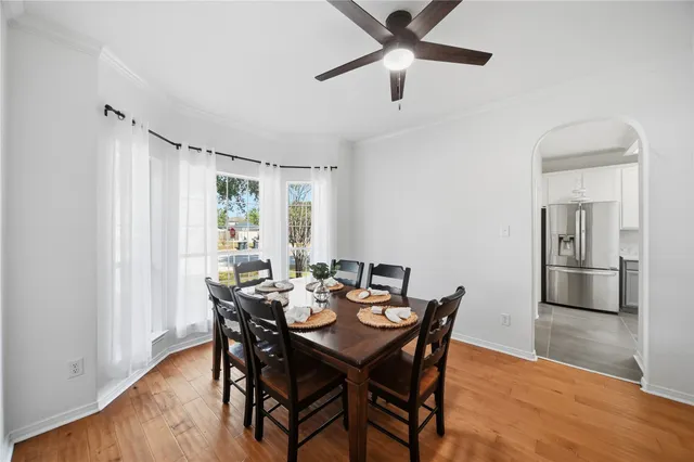 a dining room with furniture window and wooden floor