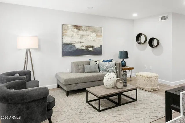 a living room with furniture and a lamp