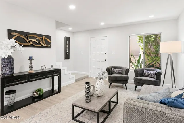 a living room with furniture and wooden floor