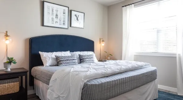 a bedroom with a bed and a window