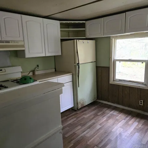 a kitchen with a refrigerator and window