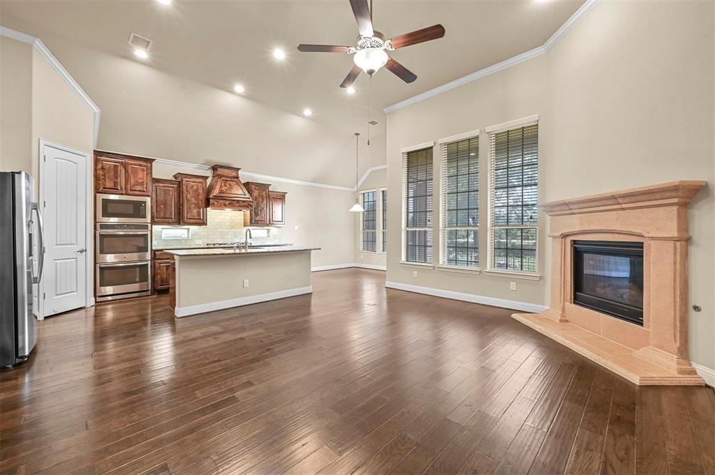 602 Whitetail Road Euless, TX 76039 - Photo 11 of 28 a view of a kitchen with furniture a ceiling fan and wooden floor
