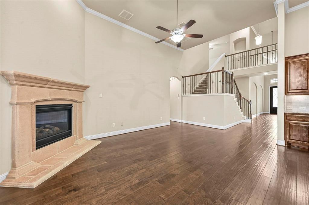 602 Whitetail Road Euless, TX 76039 - Photo 12 of 28 a view of empty room with wooden floor and fireplace