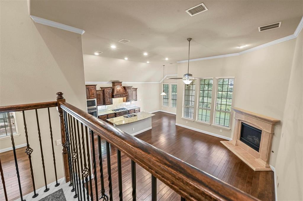 602 Whitetail Road Euless, TX 76039 - Photo 13 of 28 a view of a hallway with wooden floor and staircase