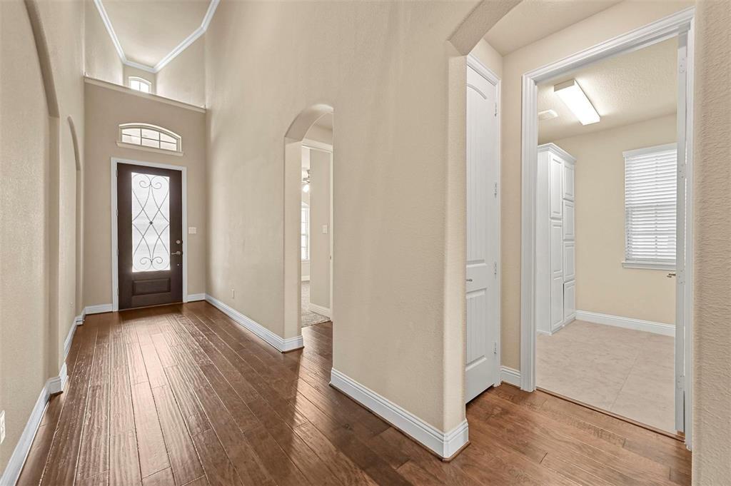602 Whitetail Road Euless, TX 76039 - Photo 4 of 28 an empty room with wooden floor and windows