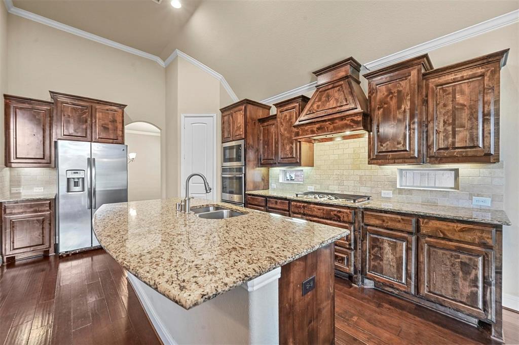 602 Whitetail Road Euless, TX 76039 - Photo 5 of 28 a kitchen with stainless steel appliances granite countertop a kitchen island a stove and a sink