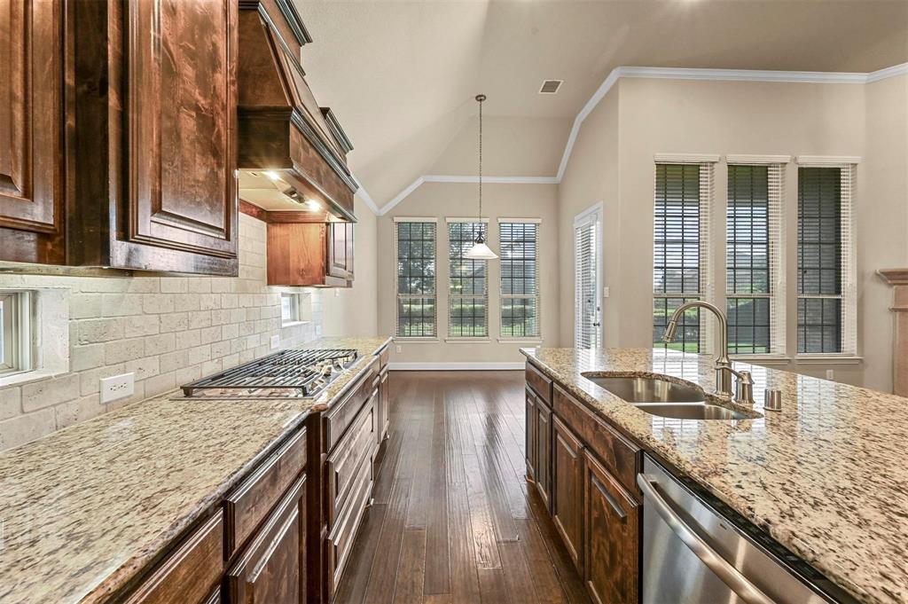 602 Whitetail Road Euless, TX 76039 - Photo 7 of 28 a kitchen with granite countertop a sink and a stove