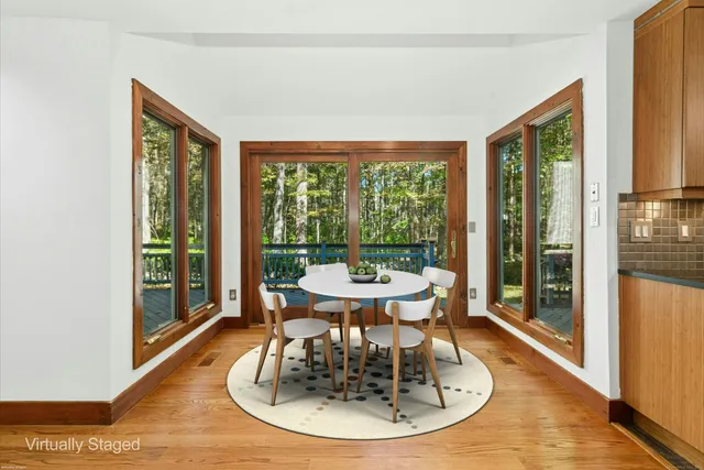 a view of a dining room with furniture window and wooden floor