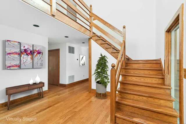 a view of entryway with wooden floor and stairs