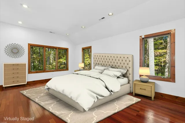 a bedroom with a large bed and a window