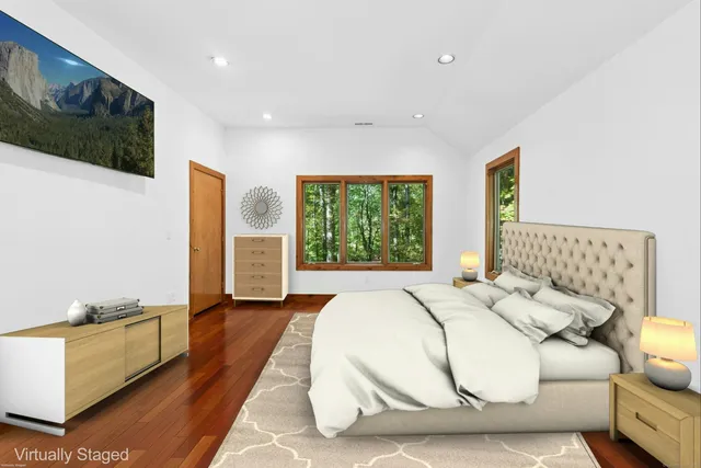 a spacious bedroom with a bed and a large window