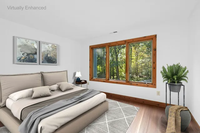 a bedroom with a large bed and a large window