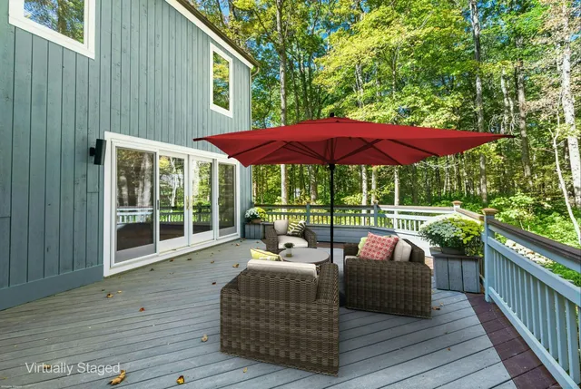 a balcony with furniture and umbrella