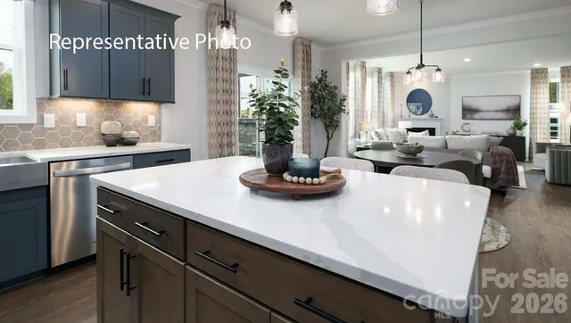 a large kitchen with sink a refrigerator and chandelier