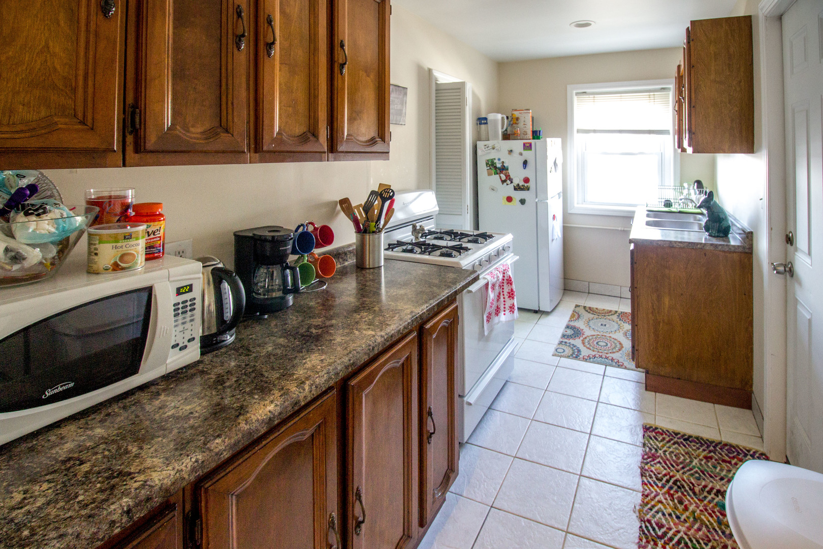 526 South York Street, Unit B Elmhurst, IL 60126 - Photo 12 of 15 a kitchen with granite countertop a sink stove and cabinets