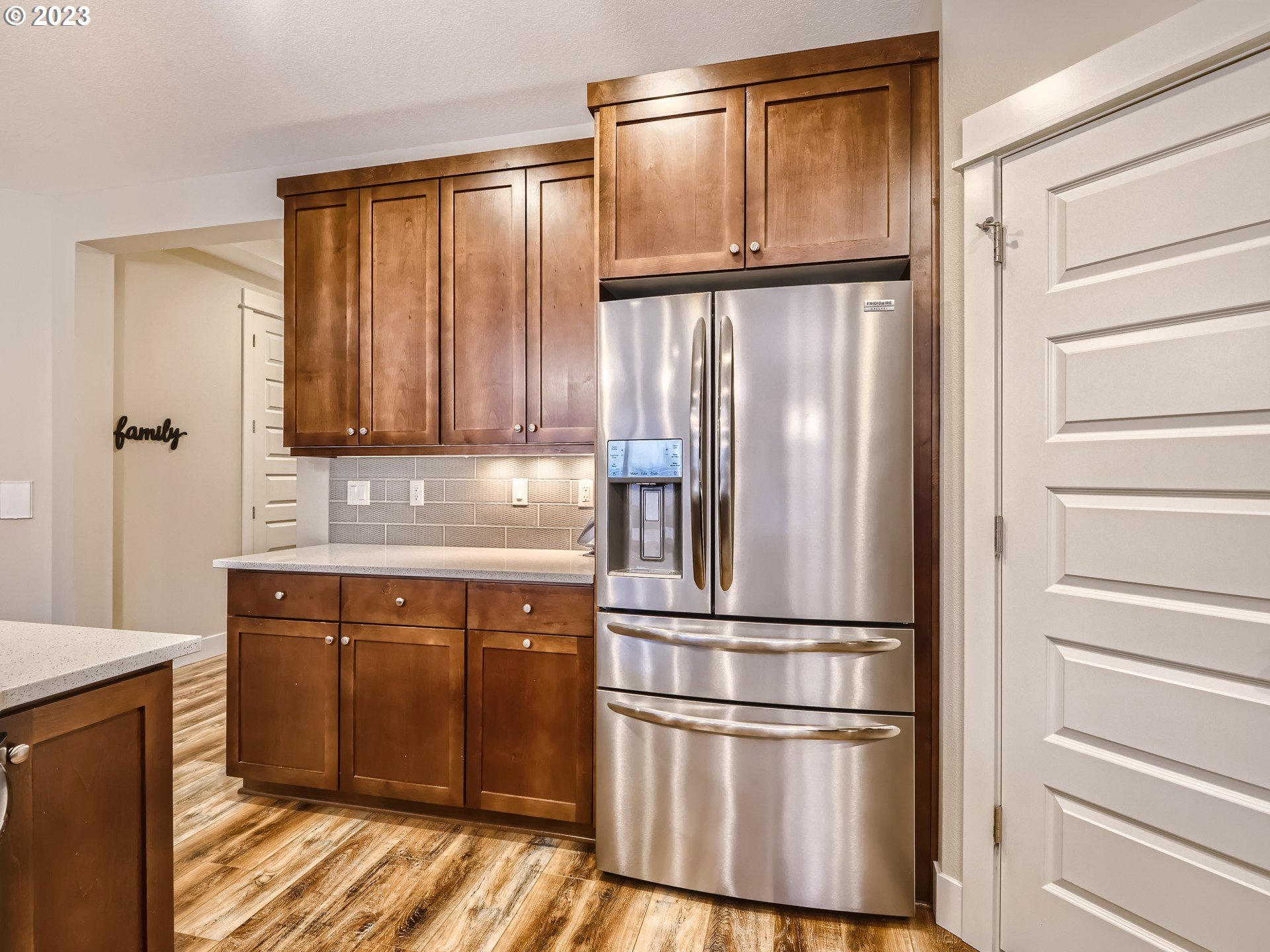 11469 Southwest Gabriel Street Tigard, OR 97224 - Photo 12 of 25 a kitchen with kitchen island wooden floor and stainless steel appliances