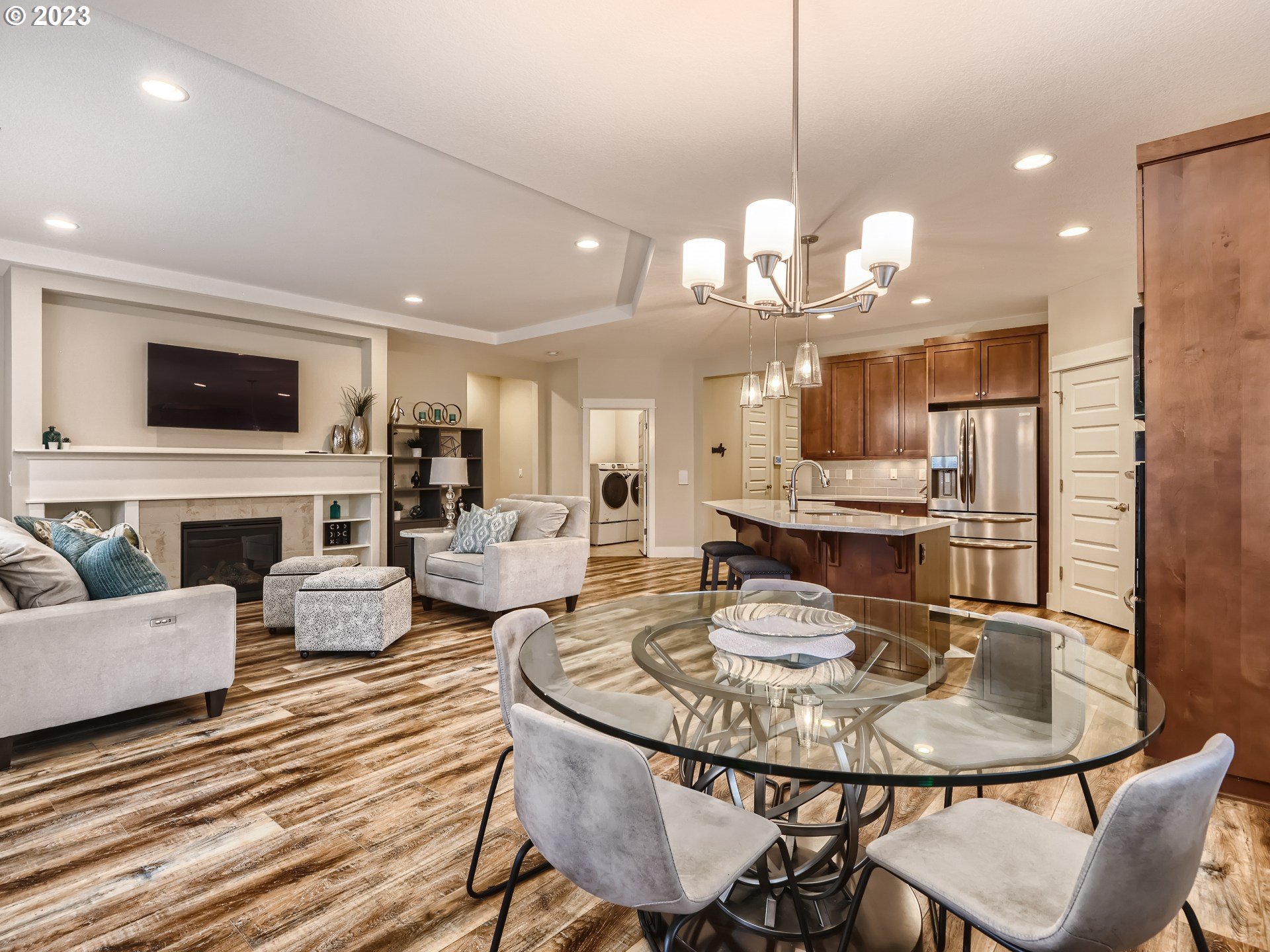 11469 Southwest Gabriel Street Tigard, OR 97224 - Photo 14 of 25 a view of a dining room with furniture a fireplace and wooden floor