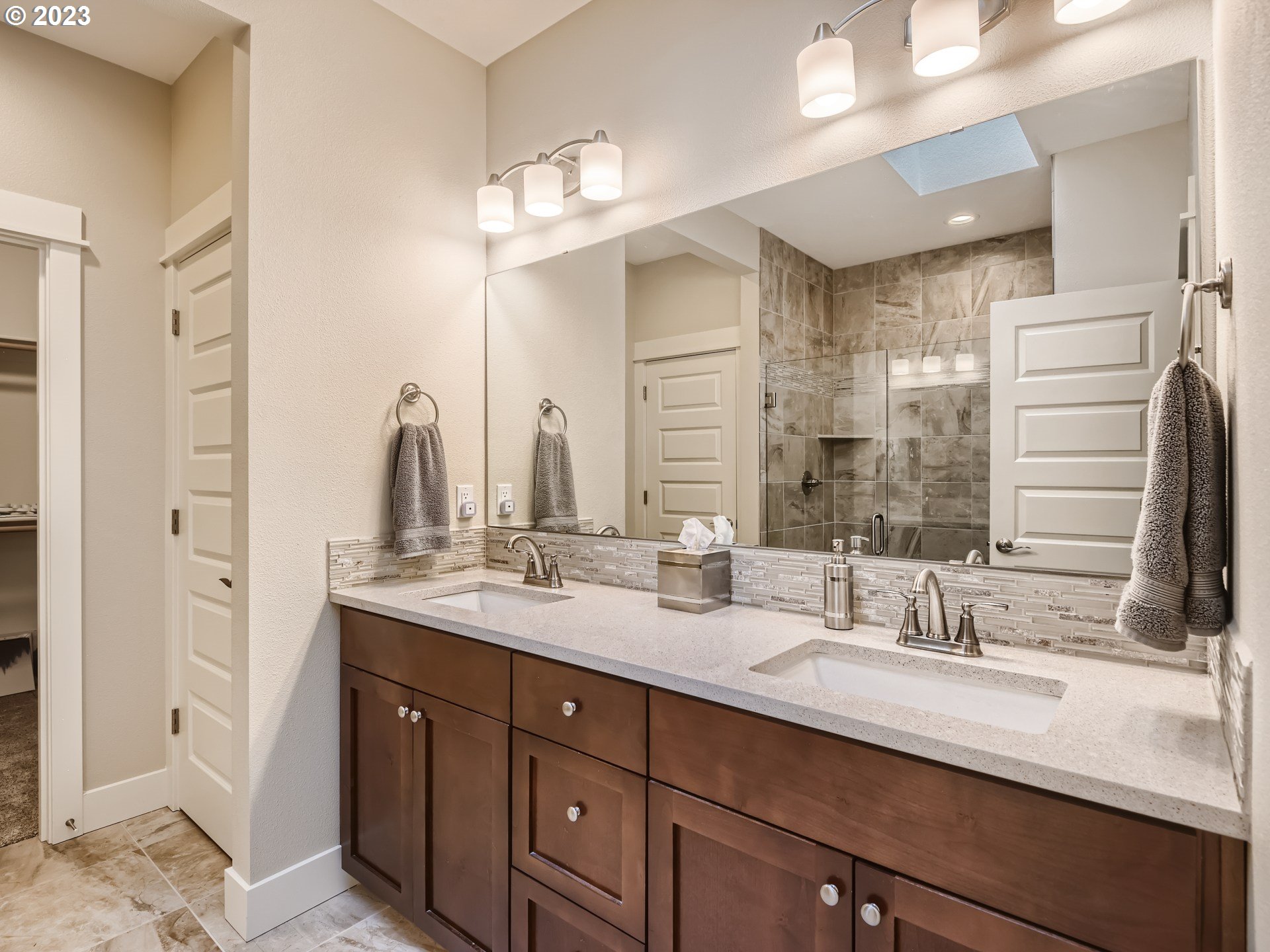 11469 Southwest Gabriel Street Tigard, OR 97224 - Photo 19 of 25 a bathroom with double vanity sinks and a mirror