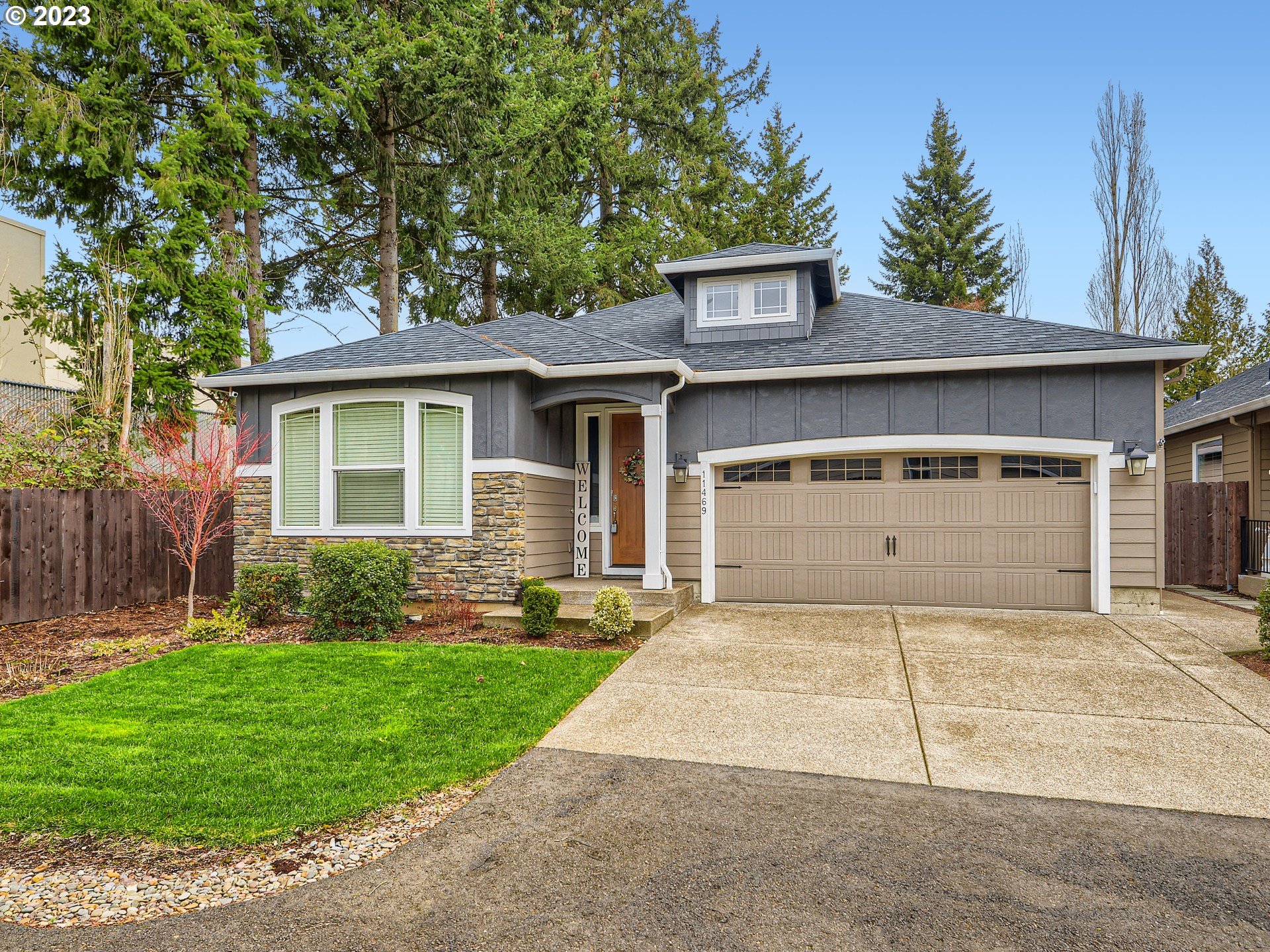 11469 Southwest Gabriel Street Tigard, OR 97224 - Photo 2 of 25 a front view of a house with a yard and garage
