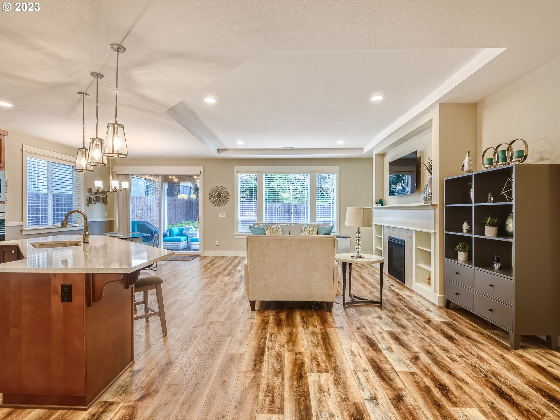11469 Southwest Gabriel Street Tigard, OR 97224 - Photo 5 of 25 a living room with a large window a table chairs and a wooden floors