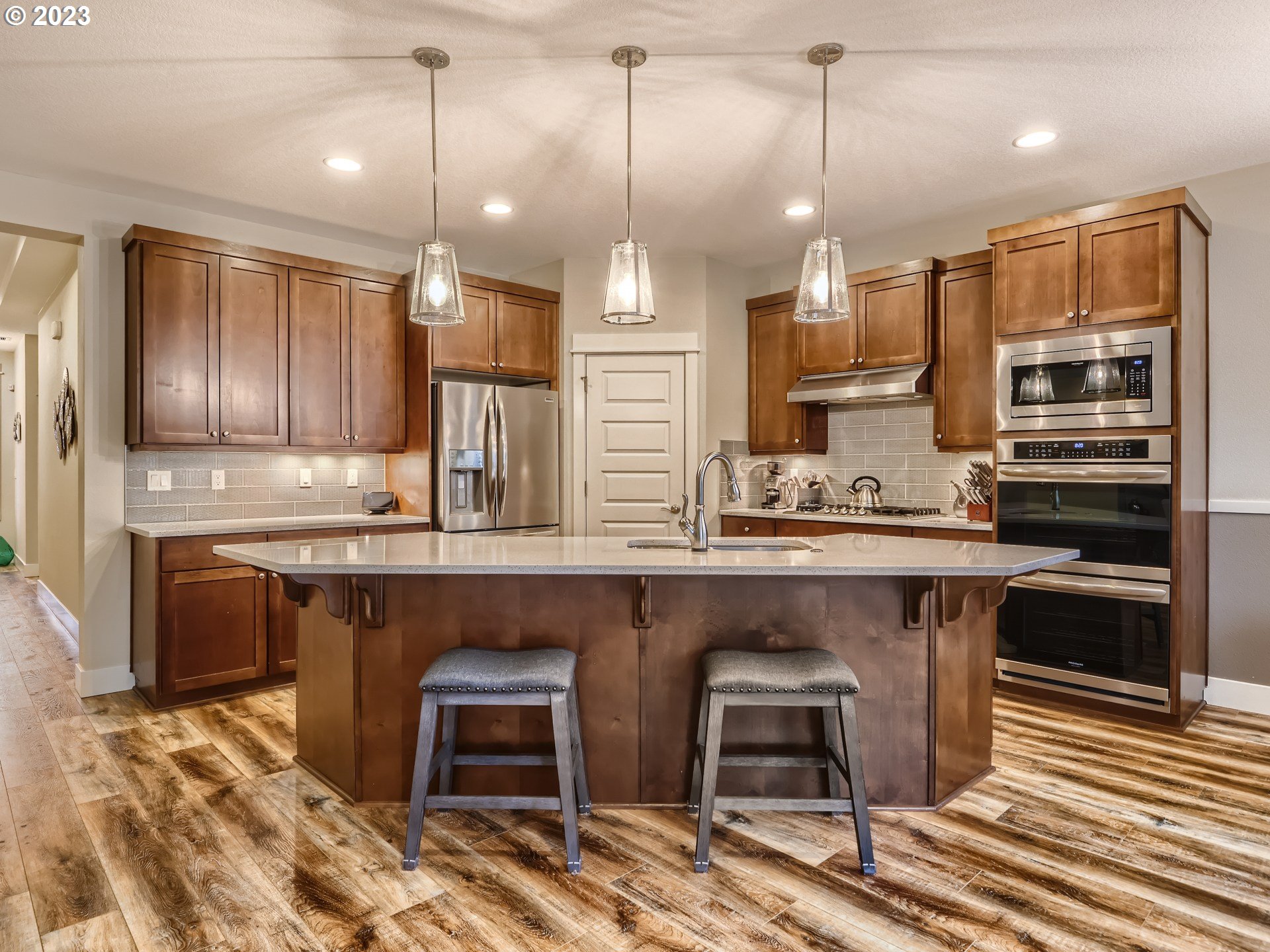 11469 Southwest Gabriel Street Tigard, OR 97224 - Photo 10 of 25 a kitchen with stainless steel appliances granite countertop a stove a sink and a refrigerator
