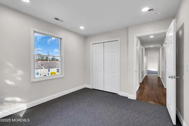 a view of an empty room and a window