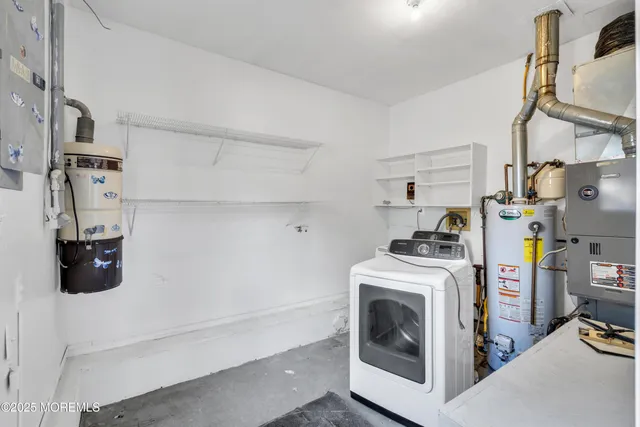 a utility room with sink dryer and washer