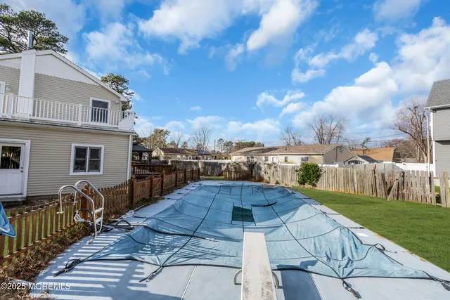 a view of a house with backyard porch and sitting area