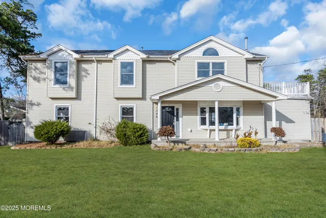 a front view of a house with a garden and yard