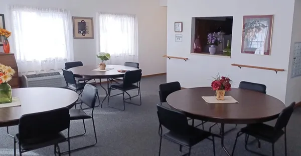 a view of a dining room with tables and chairs