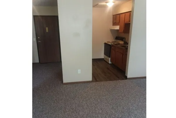 a view of a hallway with a room and a bathroom