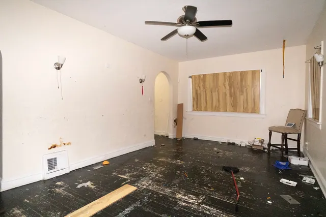 a view of a bedroom with wooden floor and ceiling fan