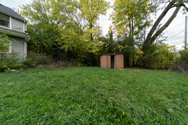 a view of a garden with furniture and a fire pit