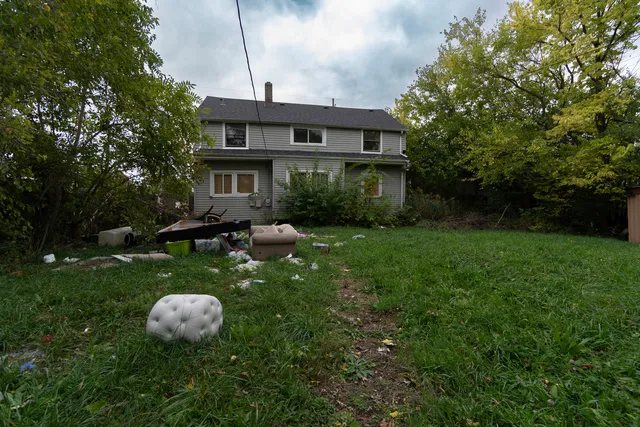 a view of a backyard with sitting area