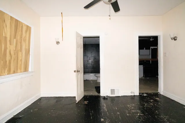 an empty room with windows and closet